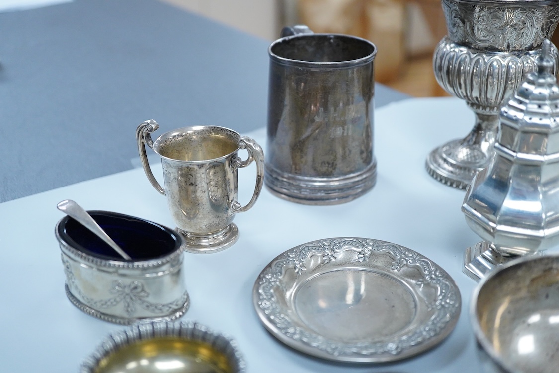 A collection of small silver wares to include a George V silver porringer, two George V silver sauce boats, a let Victorian silver sugar bowl, a George III silver goblet, with later embossed decoration, a George V small